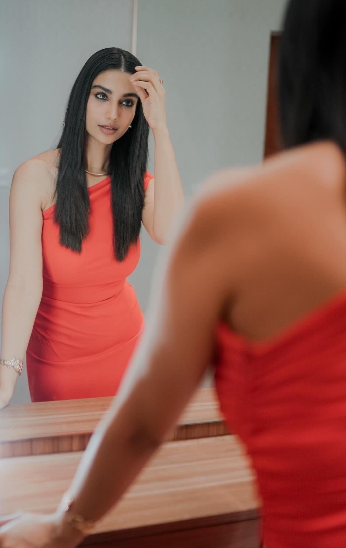 Actress Meenakshi Chaudhary Stuns in Orange Bodycon Outfit